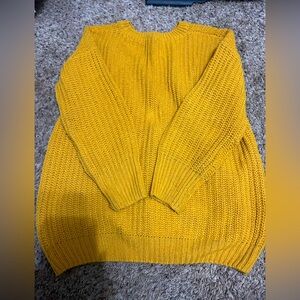 Mustard color sweater.